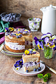 Sponge cake with blueberry cream, champagne jelly, and edible flowers