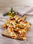 Grilled dough skewers with bacon and garlic
