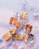 Butter biscuits decorated with nuts, sugar nibs and coloured sprinkles