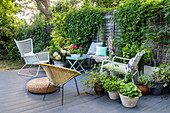 Garden furniture and potted plants on a wooden terrace