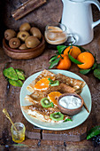 Crepes with tangerines and kiwis