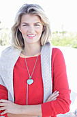 A young blonde woman wearing a red jumper