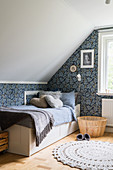 A girl's room in grey-blue tones in the attic