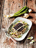 Eel and black pudding made in a Beefer on a bed of soba noodles