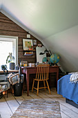 A guest room with desk in the attic