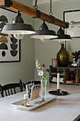 A vintage metal and wood pendant lamp above a dining table