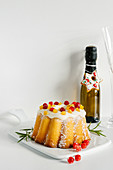 Orange bundt cake glazed and decorated with cranberries for Christmas