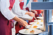 Professional chefs plating food