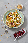 Broccoli power salad with pomegranate seeds and feta cheese