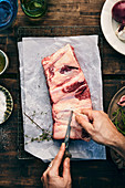Raw spare ribs being prepared for grilling