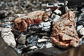 Steak cooked directly on coals