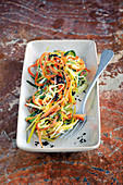 Vegan vegetable spaghetti with grapefruit and olives