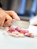 A red onion being chopped