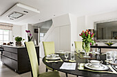 Open plan kitchen dining room with highback upholstered chairs