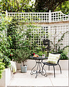Chair and table in courtyard garden of Victorian terrace