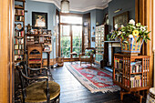 Arts and Crafts style revolving bookcase in drawing room of Victorian terrace