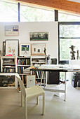 Chair and old desk in studio with glass wall in artist's house