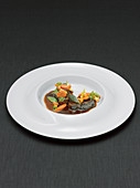Veal cheeks with baby vegetables