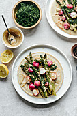 Chickpea pancakes with asparagus roasted radish topped with tahini sauce