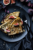 Crepes with wildberry jam figs and crushed walnuts