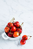 Fresh ripe red cherry with stalks in white ceramic pot