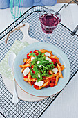 Light vegetable pasta with tomatoes, rocket and mozzarella