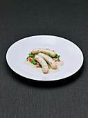 Seafood and veal sausage with mustard sauce and savoy cabbage