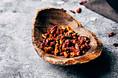 Dried chili peppers in a wooden bowl