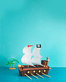 A pirate ship cake (layer cake decorated with chocolate bars an wafer rolls)
