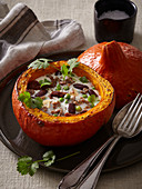 Pumpkin stuffed with meat, beans and sun-dried tomatoes
