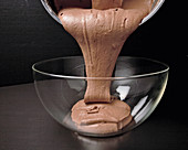 Mousse au chocolat being poured into a bowl