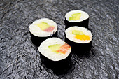 Sushi – avocado and salmon maki, cucumber and mango maki