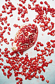 A pomegranate surrounded by individual seeds