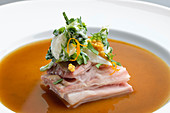 Lamb belly with onion salad and brown onion broth