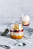 Cranberry and sea buckthorn sauce with granola in glass jar