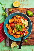 Rice with chicken in mexican style with red beans, green peas, red pepper and coriander