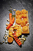 Scallops grilled on a salt tile with papaya and cashew