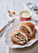 Roast pork belly with almond-nut stuffing and horseradish dip