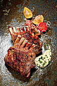 Grilled rack of lamb with tomato salad and hummus