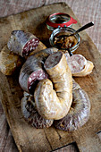 Cold sour Rädle sausages – carpaccio of light and dark brawn with a leek relish