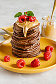 Chocolate pancakes with peanut butter and raspberry