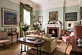 Vintage lamp on table with green curtains and lit fire