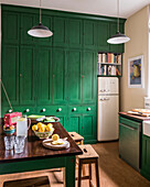 Fresh lemonade on table in bright green kitchen