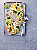 Breakfast naans with avocado and fried eggs