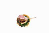 Lamb chop on artichoke base with spinach and tomato