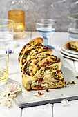 Pull-apart bread with feta cheese, dried tomatoes and pine nuts