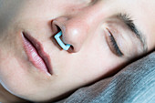 Woman using a nasal clip