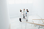 Doctors meeting on landing of stairs