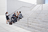 Business people meeting on urban stairs