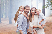 Portrait of smiling family in woods